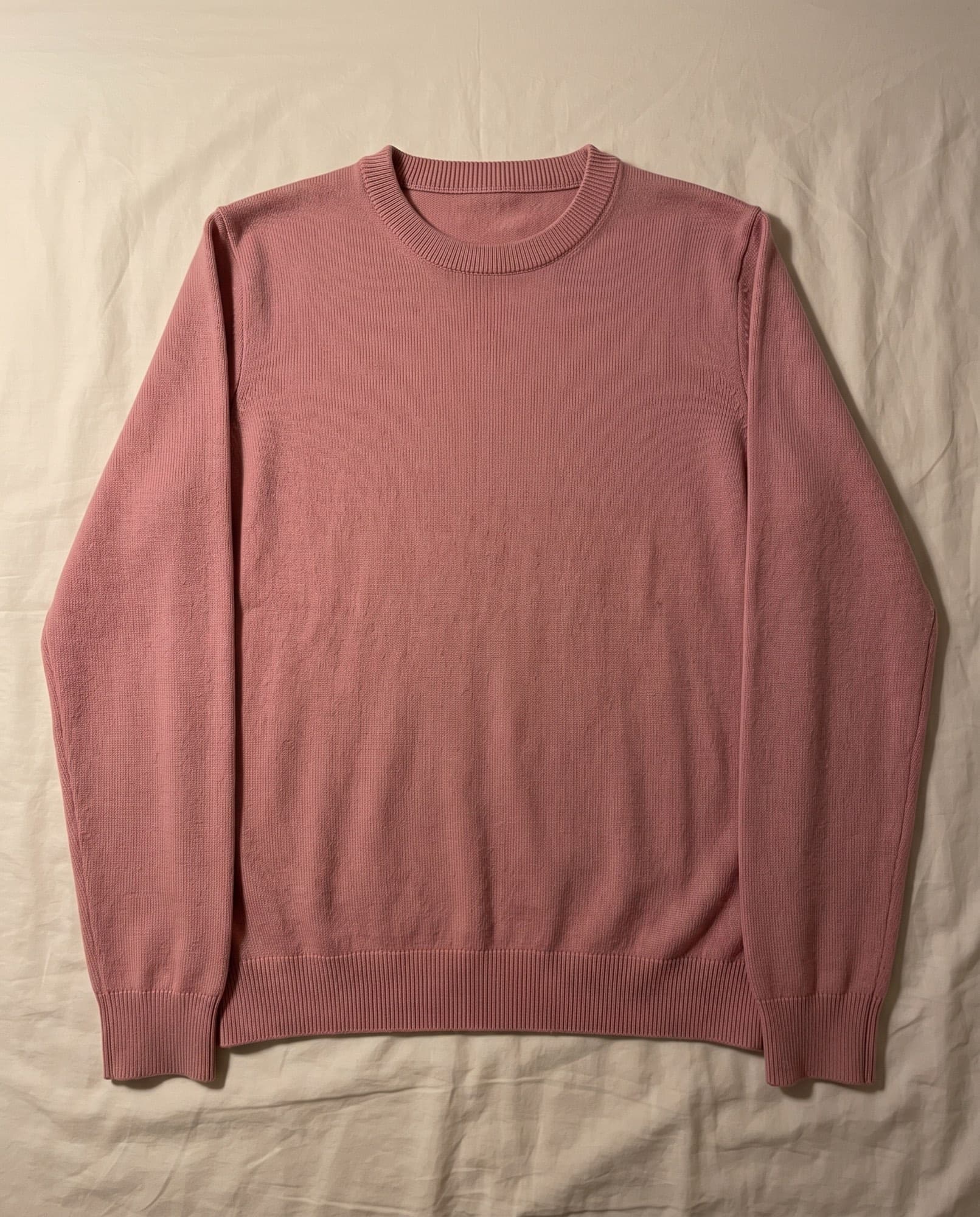 A sweater laid out and shot on a phone at home, and the same sweater on a model